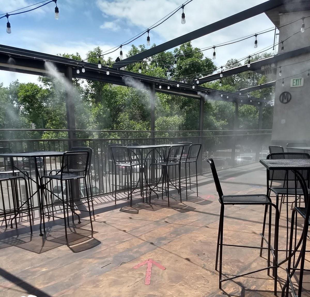 The roof deck in daylight with the misters on