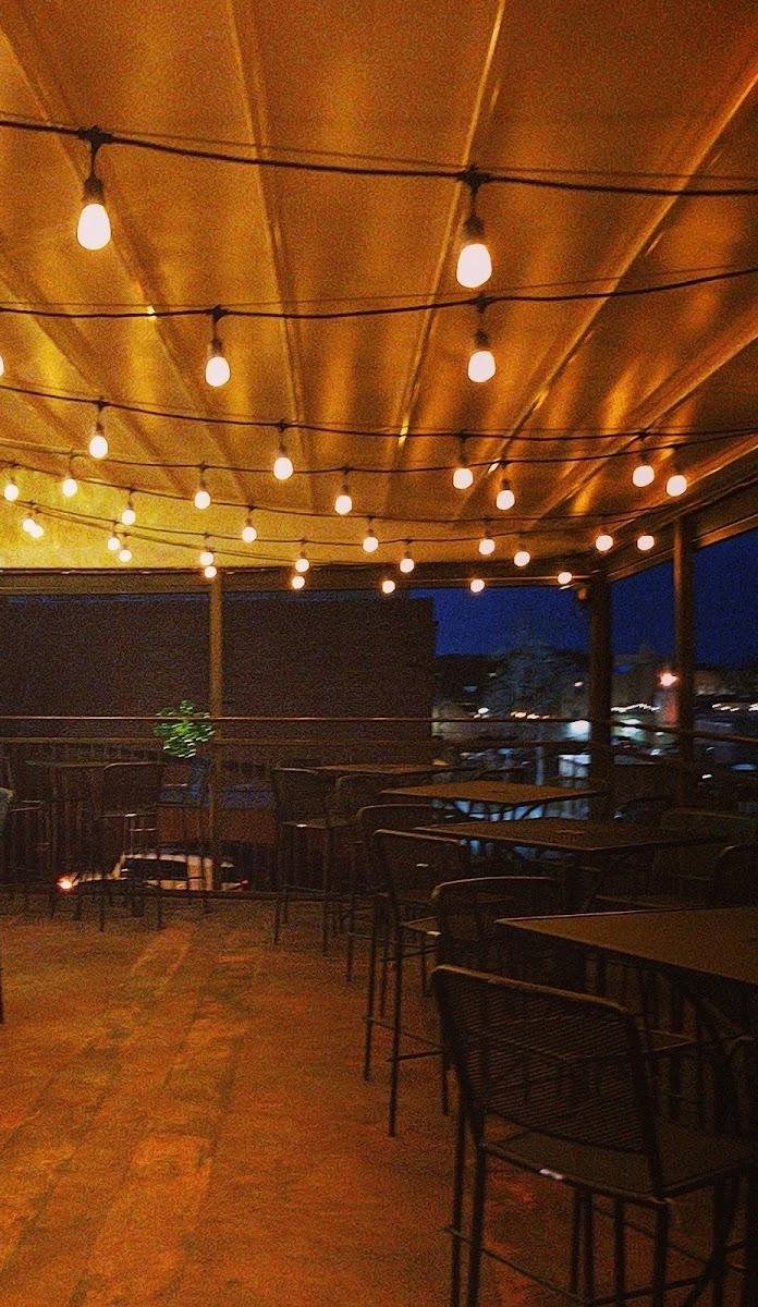 String lights over the roof after dark