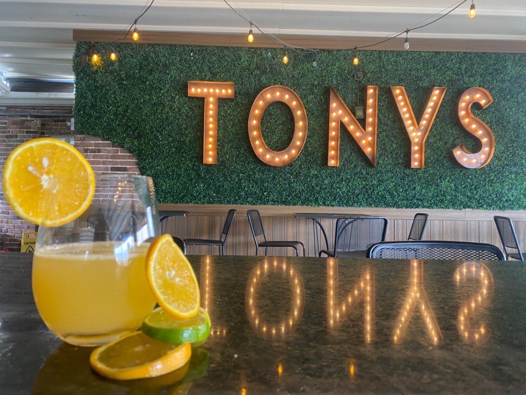 TONYS in marquee lights on the green wall up on the roof